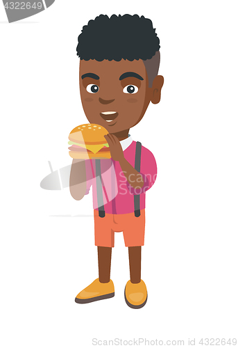 Image of Little african-american boy eating a hamburger.