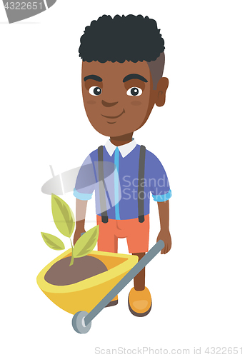 Image of Boy pushing wheelbarrow with soil and plant.