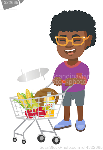 Image of Little african boy with his shopping trolley.