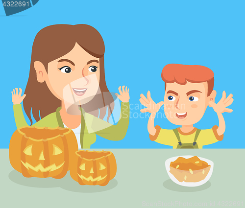 Image of Mother and son carving pumpkins for Halloween.