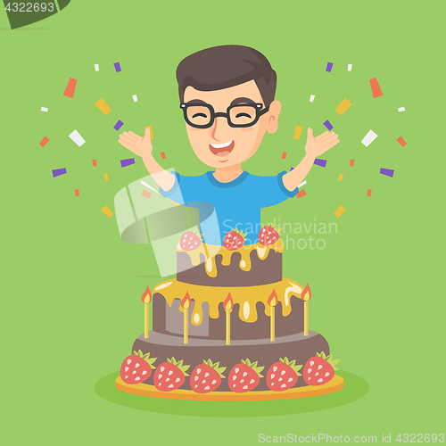 Image of Little caucasian boy jumping out of a large cake.