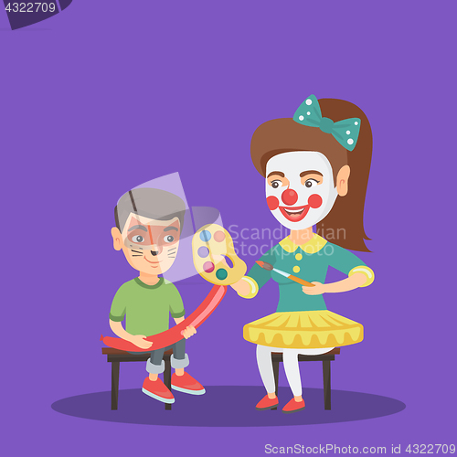 Image of Woman animator painting the face of a boy.