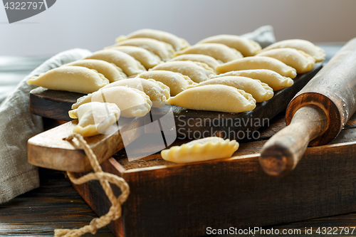 Image of Fresh dumplings with cottage cheese on the kitchen table.