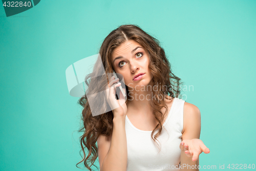 Image of The portrait of disgusted woman with mobile phone