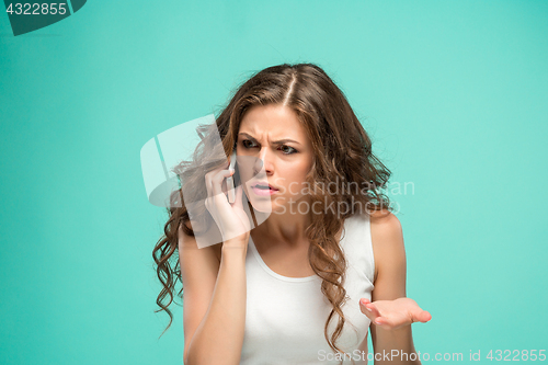 Image of The portrait of disgusted woman with mobile phone