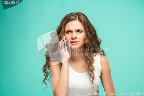 Image of The portrait of disgusted woman with mobile phone