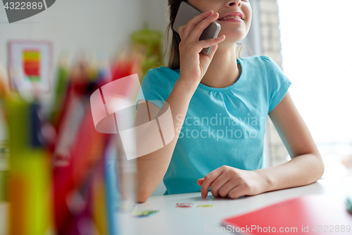 Image of close up of girl calling on smartphone at home