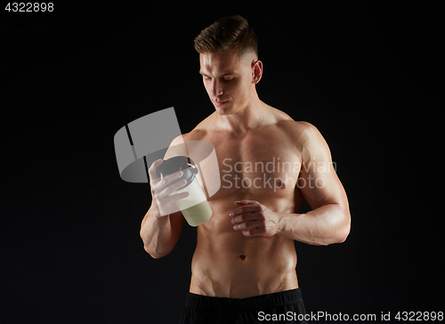 Image of young man or bodybuilder with protein shake bottle