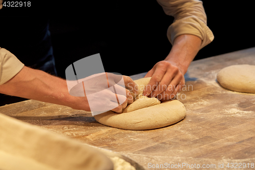 Image of chef or baker cooking dough at bakery