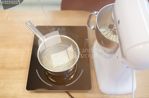 Image of electric mixer and pot on stove at kitchen