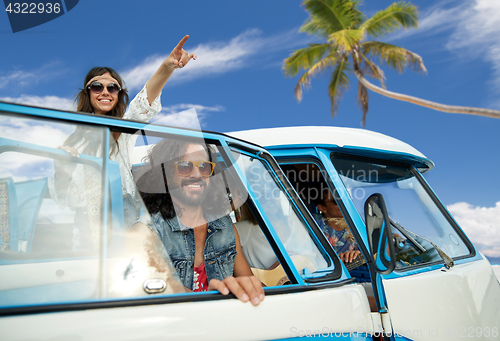 Image of happy hippie friends in minivan car on beach