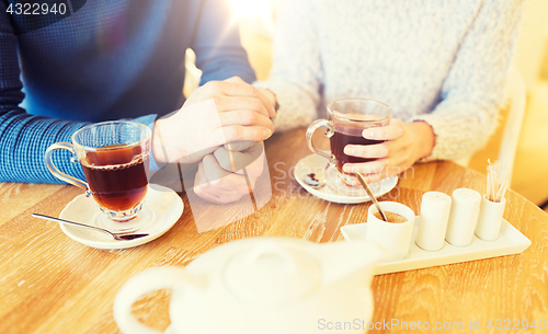 Image of close up of couple drinking tea at cafe