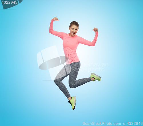 Image of happy smiling sporty young woman jumping in air