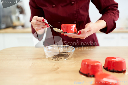 Image of chef decorating mirror glaze cakes at pastry shop