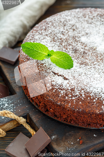 Image of Chocolate cake sprinkled with powdered sugar.