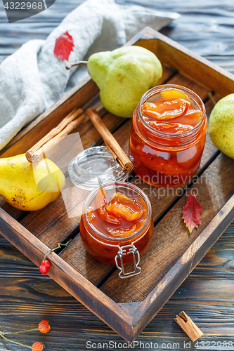 Image of Jam from pears in glass jars and fresh pear.