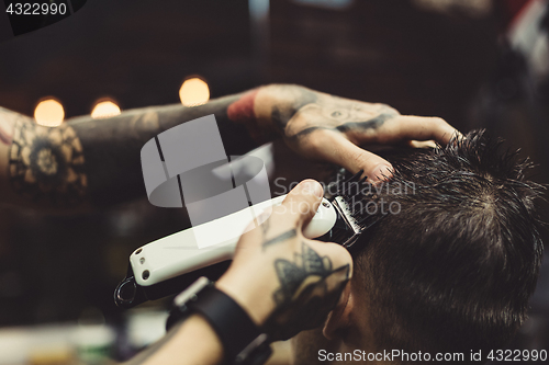 Image of Barber shaving man in chair