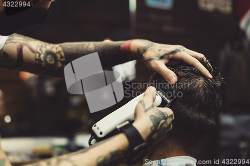 Image of Barber shaving man in chair