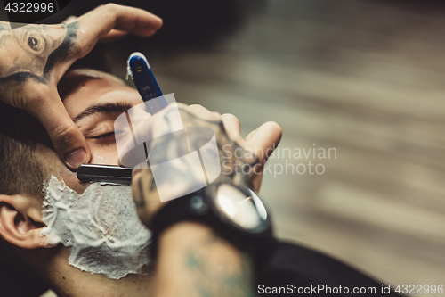 Image of Barber shaving client