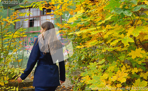 Image of Teen girl in the autumn forest and hut