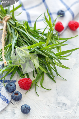 Image of Bunch of fresh tarragon and berries.