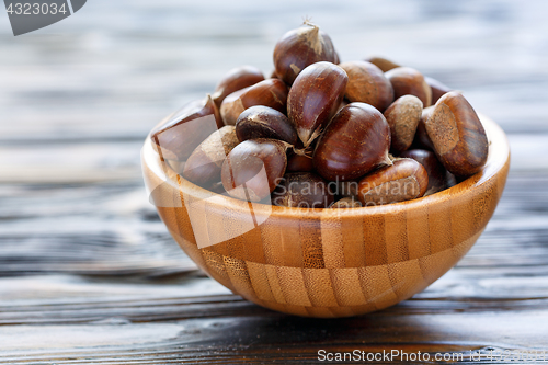 Image of Fresh chestnuts in a wooden bowl.