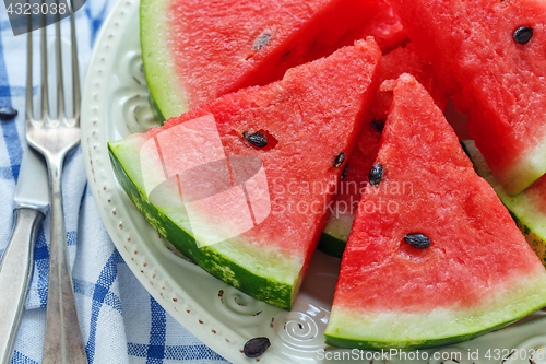 Image of Dish with slices of ripe watermelon closeup.