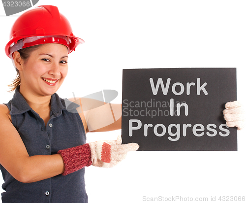 Image of Work In Progress Sign Held By Construction Worker