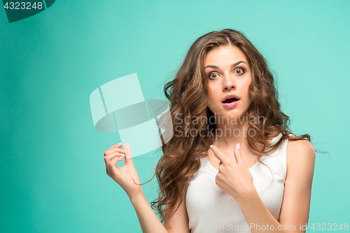 Image of Frustrated young woman having a bad hair on blue