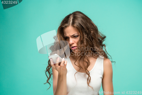 Image of The portrait of disgusted woman with mobile phone