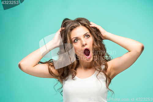 Image of Portrait of young woman with shocked facial expression