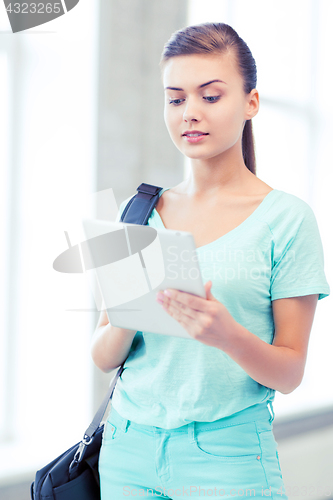 Image of smiling student with tablet pc in college