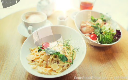 Image of close up of pasta in bowl on table at restaurant