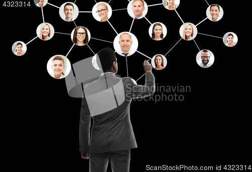 Image of businessman working with network contacts icons