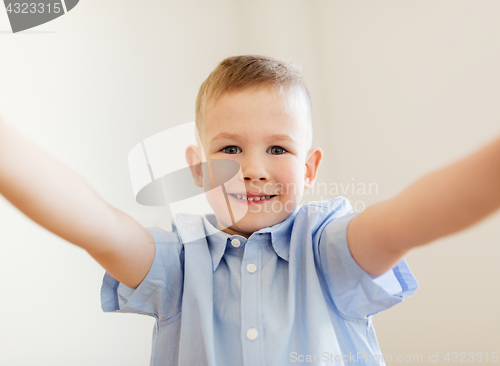 Image of happy smiling little boy taking selfie