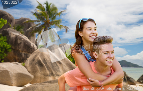 Image of happy teenage couple having fun on summer beach