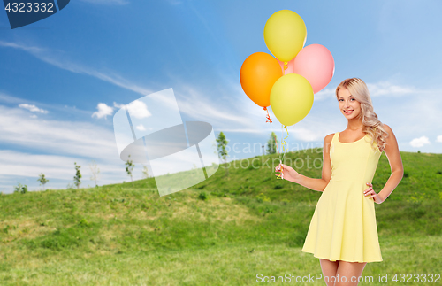 Image of happy woman in summer dress with air balloons