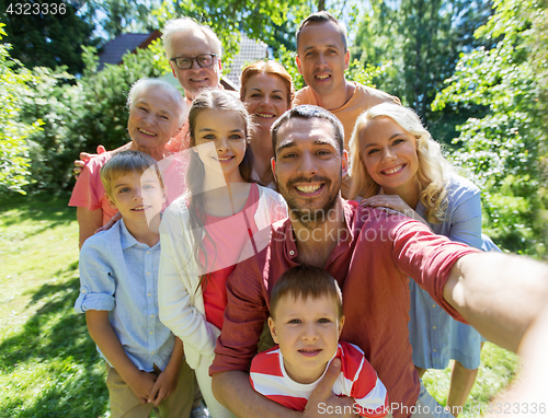 Image of happy family taking selfie in summer garden