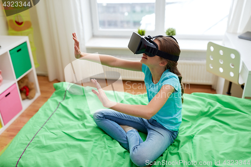 Image of happy girl in vr headset or 3d glasses at home
