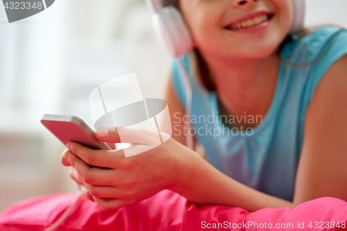 Image of girl in headphones listening to music at home