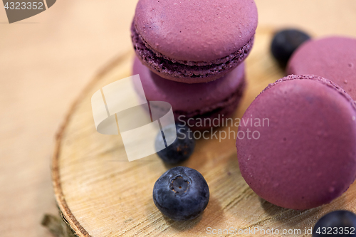 Image of blueberry macarons on wooden stand