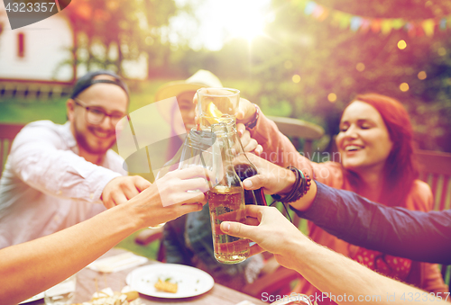 Image of happy friends with drinks at summer garden party