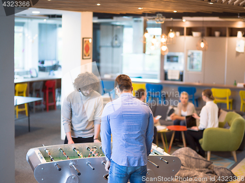 Image of Office People Enjoying Table Soccer Game