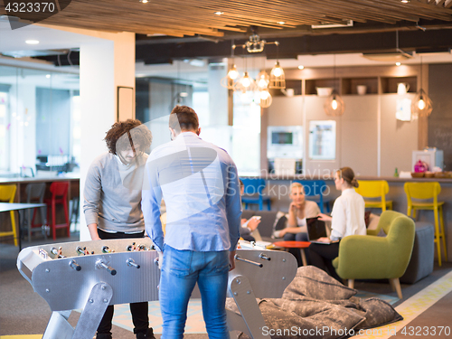 Image of Office People Enjoying Table Soccer Game