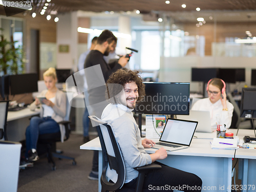 Image of businessman working using a laptop in startup office