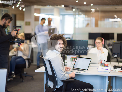 Image of businessman working using a laptop in startup office