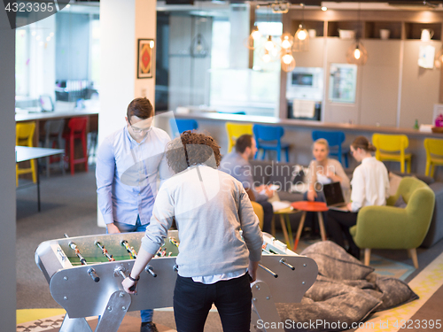 Image of Office People Enjoying Table Soccer Game