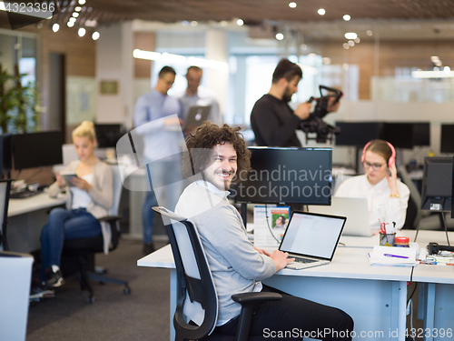 Image of businessman working using a laptop in startup office