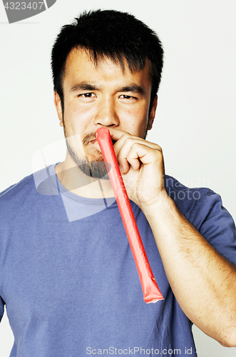 Image of young cute asian man on white background gesturing emotional, po