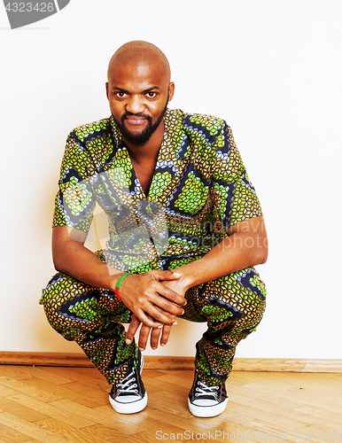 Image of portrait of young handsome african man wearing bright green nati